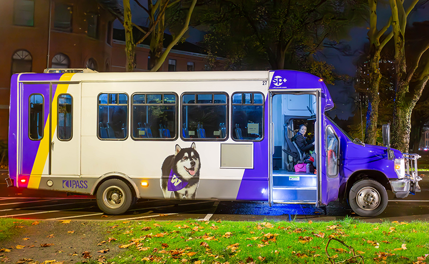 side view of shuttle with purple and gold UW colors and Dubs the UW mascot on the side