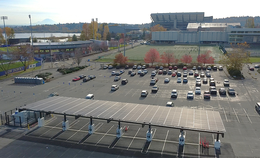 solar canopy in parking lot with Husky Stadium in the background