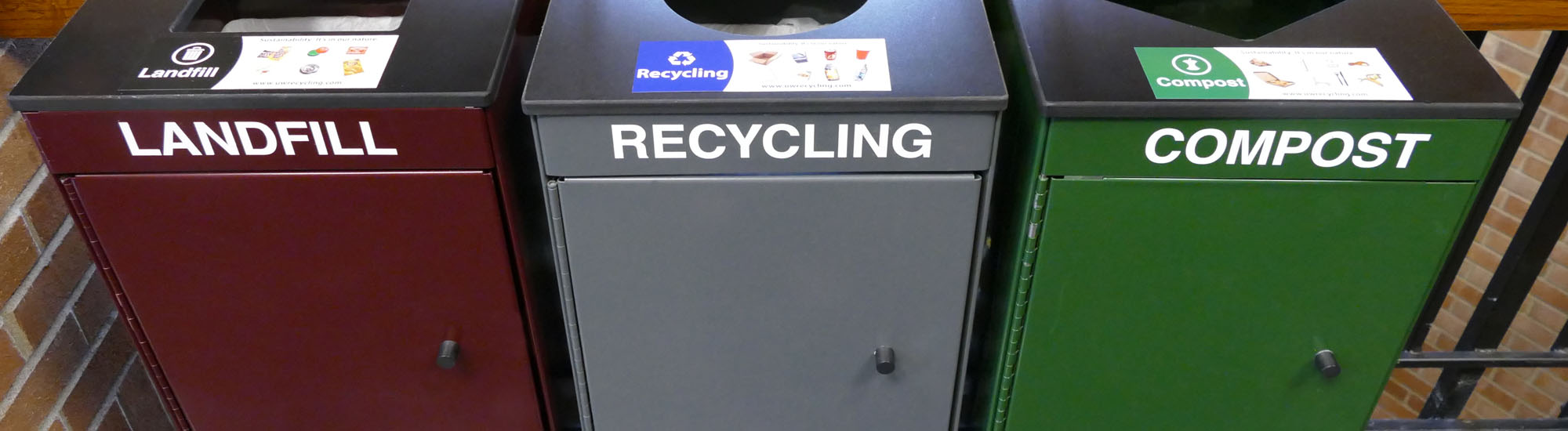 Metal public area bins sitting inside of building.