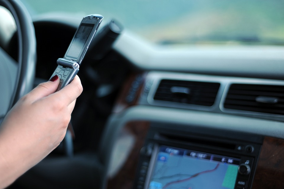 Distracted driving: mobile phone in a driver's hand