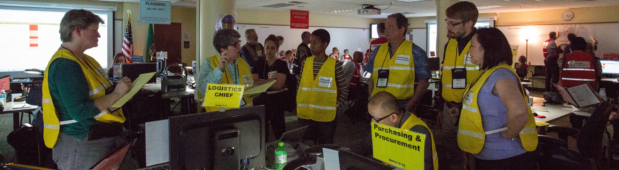A team of logistics coordinators meet to discuss how to respond to an emergency scenario.
