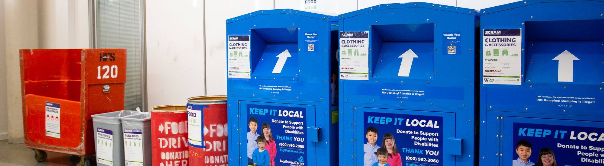 blue and red bins against a wall