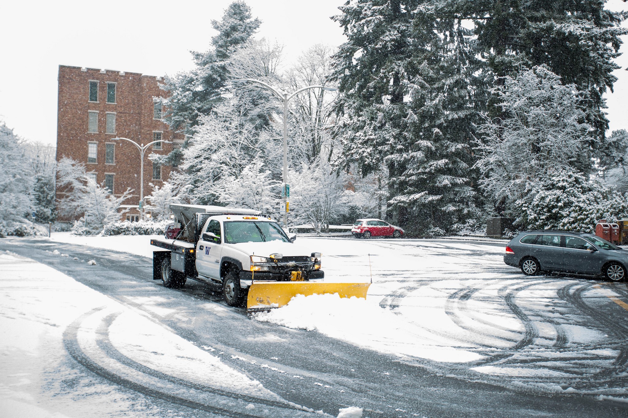 A plow clears a parking lot at the University of Washington