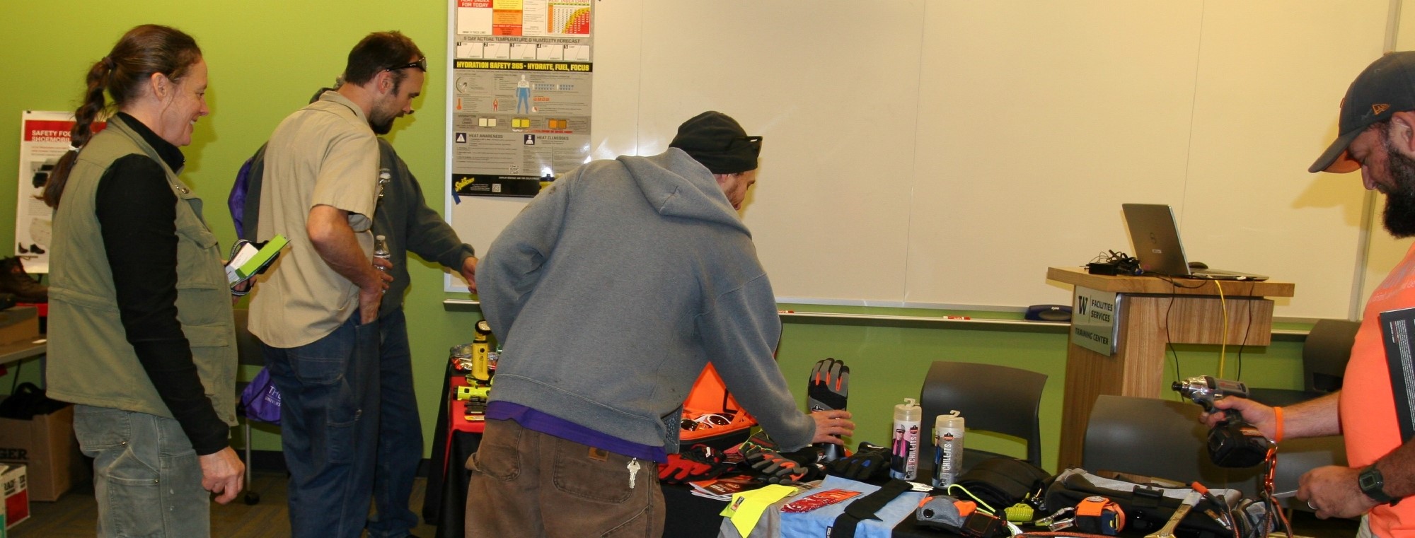 Facilities Services employees examine safety equipment