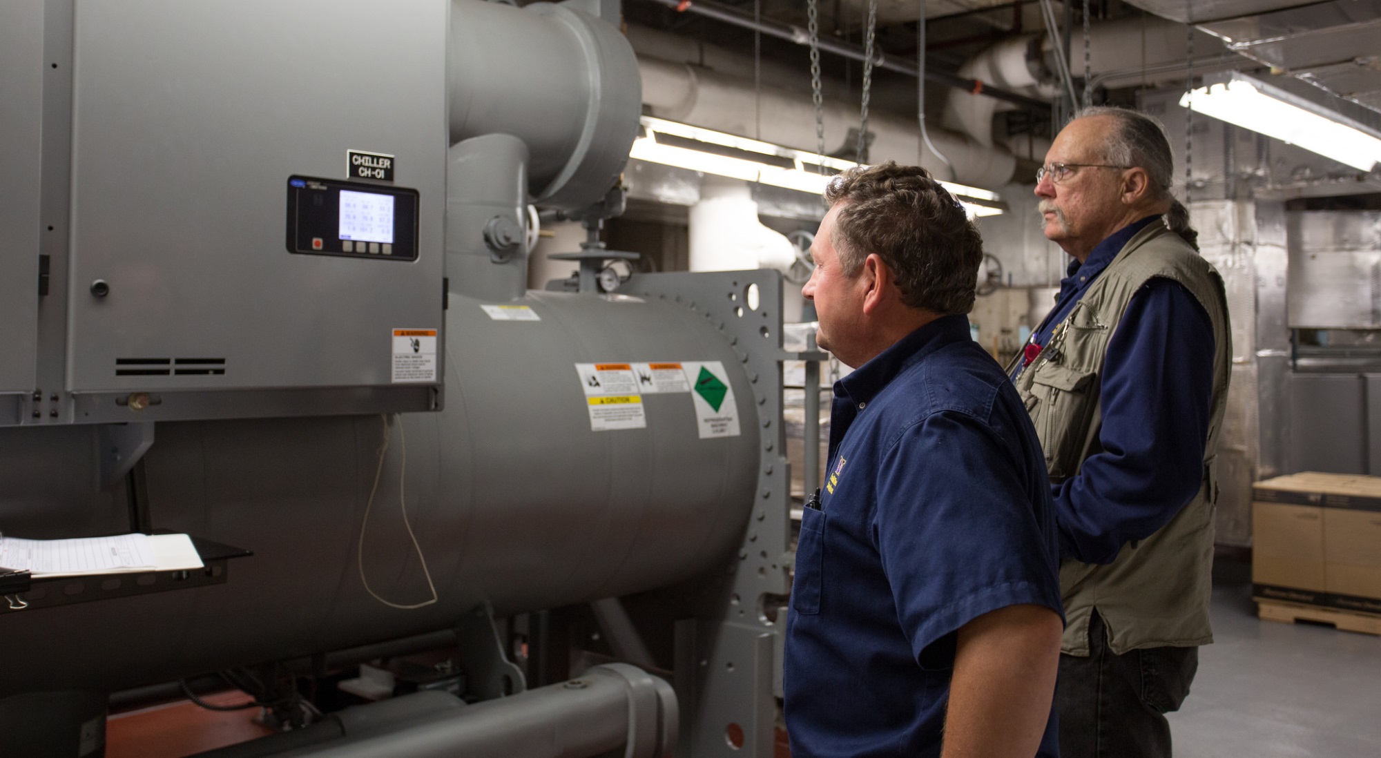 Peter Gorokhovskiy and Eric Johnston check on the tower’s chiller system during an after-hours event.