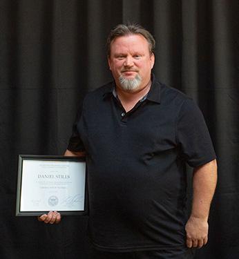 Man standing with certificate