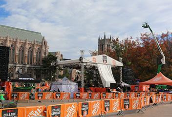 stage under construction on Red Square with Gerberding Hall and Suzzallo Library in the background