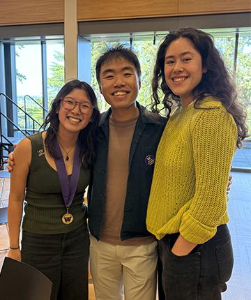 two women and one man standing together