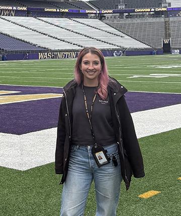 woman standing on the field at Husky Stadium