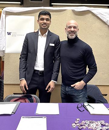 two men standing at a booth