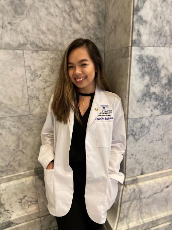 Pharmacy student Felecity Estrella in white lab coat