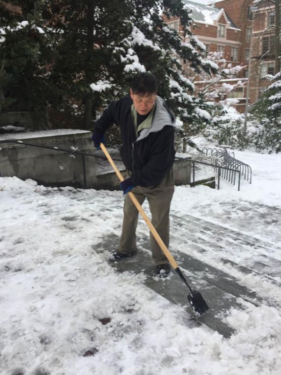 Kun Won Suh clearing snow from steps