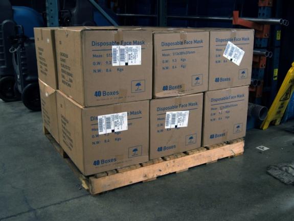 Boxes of disposable face masks on a pallet