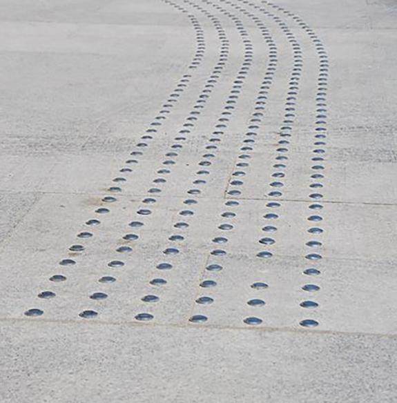 Closeup of tactile paving on a sidewalk 