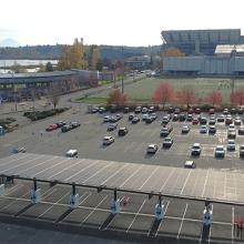 solar canopy in parking lot with Husky Stadium in the background