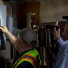 Bill Sieg and Curtis Nilson fix a power outage in the Wilcox Annex.