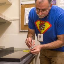 Andy Schlais from Maintenance and Construction installs a counter top in Health Sciences