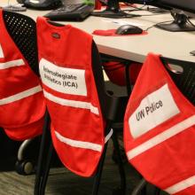Reflective vests for department representatives draped on chairs