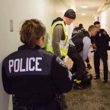 UW Police officers take part in an active shooter training exercise in the now-empty McCarty Hall
