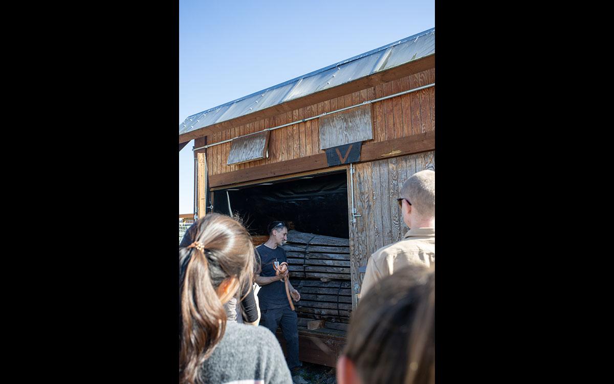 structure with doors open shows tree that has been cut into planks