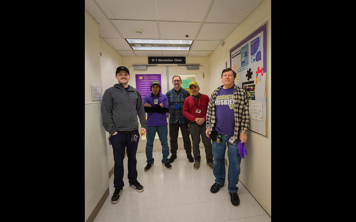 people standing in a hallway outside of lab