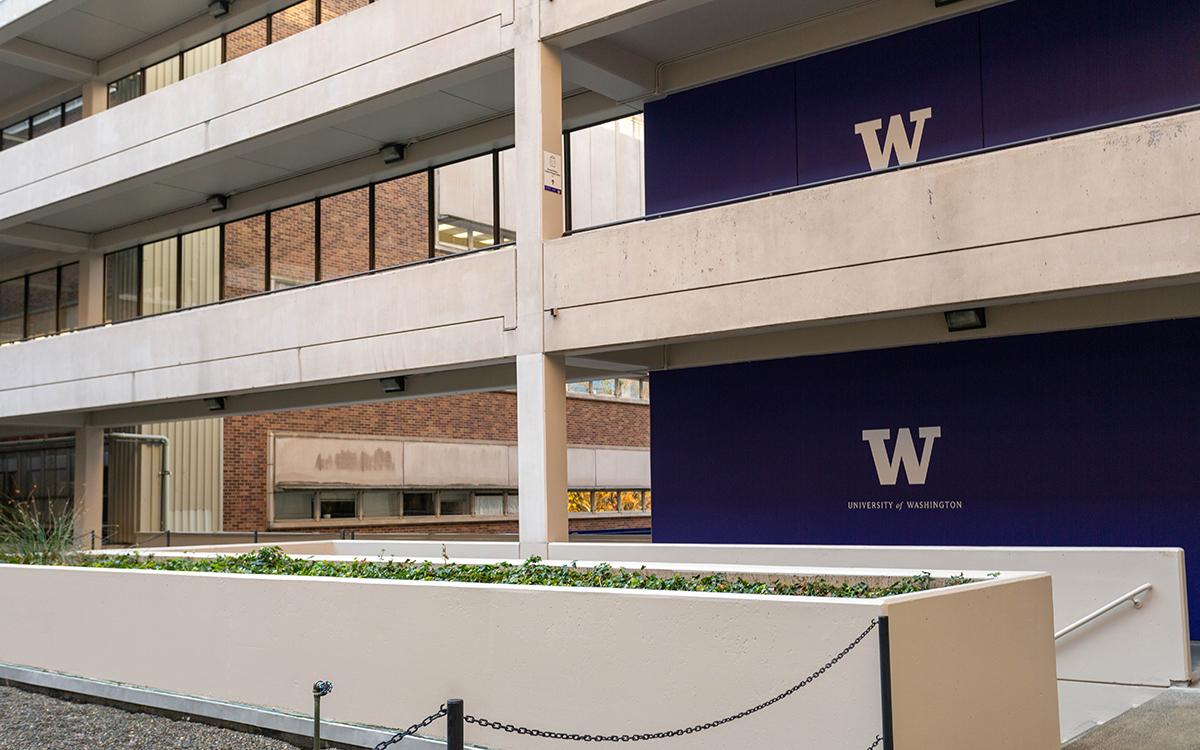 courtyard with purple wall with UW logo