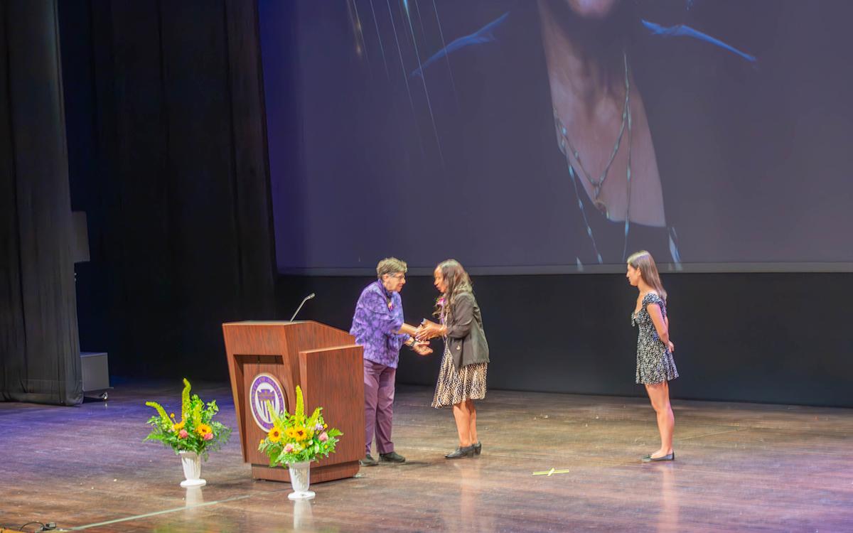 President Cauce shakes Leula Amaha's hand