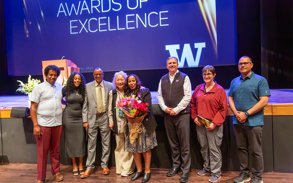 Leula Amaha stands with family and UW Facilities staff