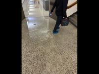man walking through puddle in stair landing