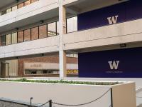 courtyard with purple wall with UW logo