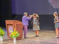 President Cauce puts medal on Leula Amaha