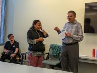 Interim Vice President of Facilities Rod Worden at a small meeting speaks about Leula Amaha, who is standing nearby