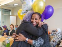 Leula Amaha hugging woman with purple hair