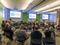 woman speaks in front of a room