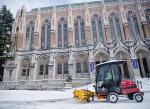 snow plow clears snow in front of Suzzallo library