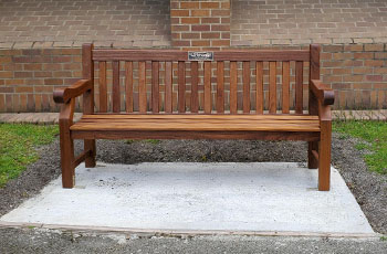 memorial bench on a cement pad