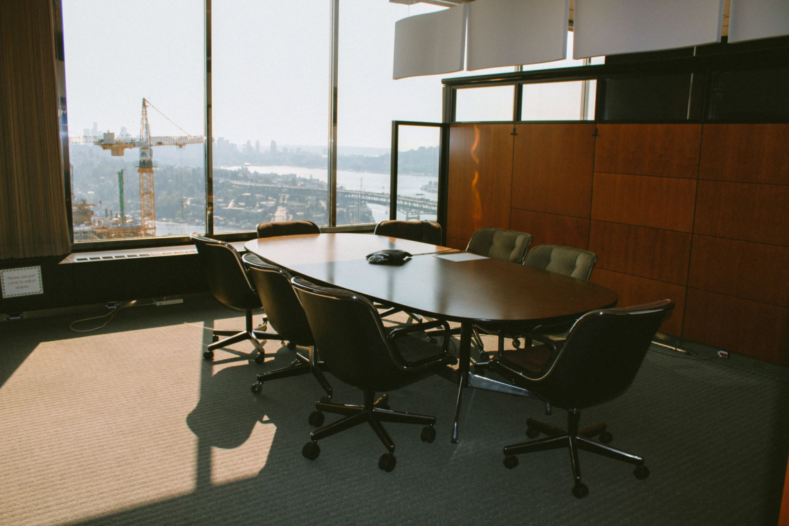 Alki Conference Room with a view of downtown Seattle and a construction crane on a sunny day