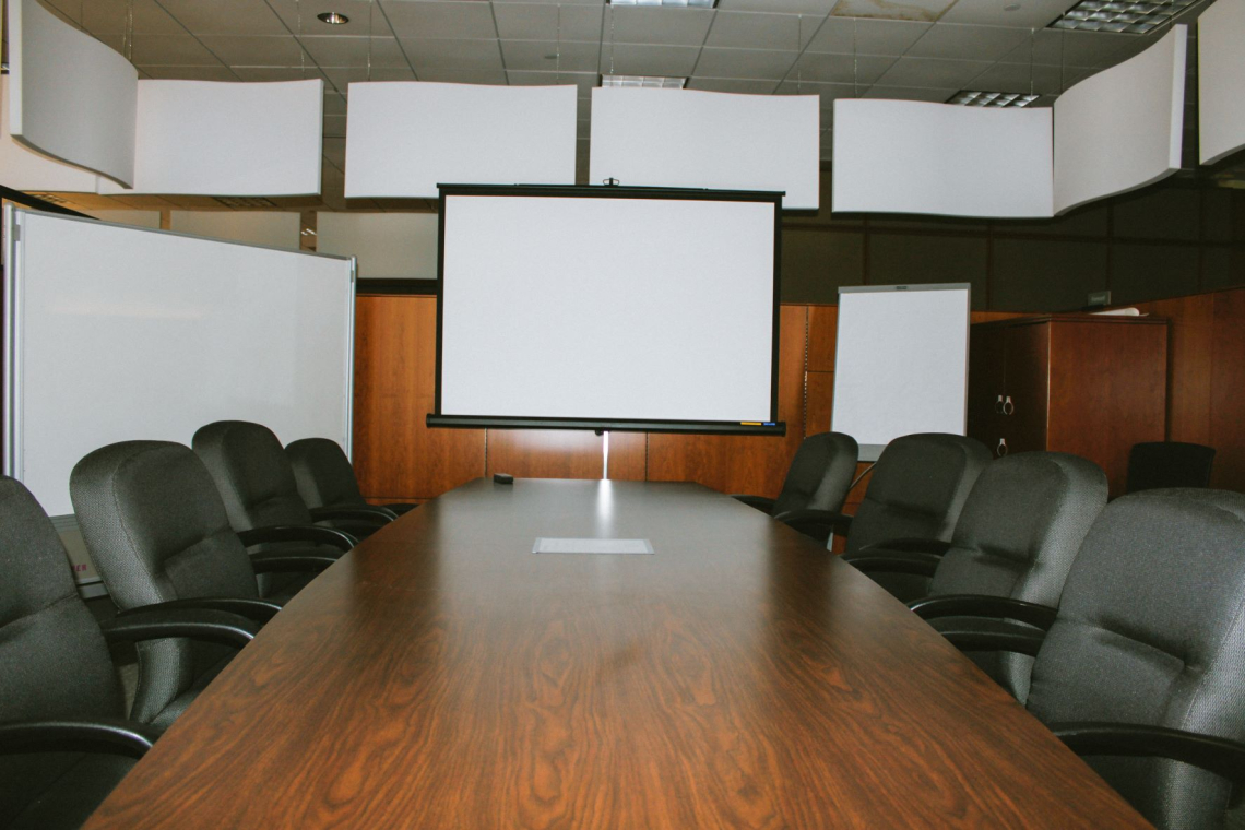 Fremont Conference Room with a cushy chairs and a projector screen