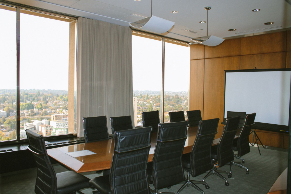 the Glass conference room with a projector screen