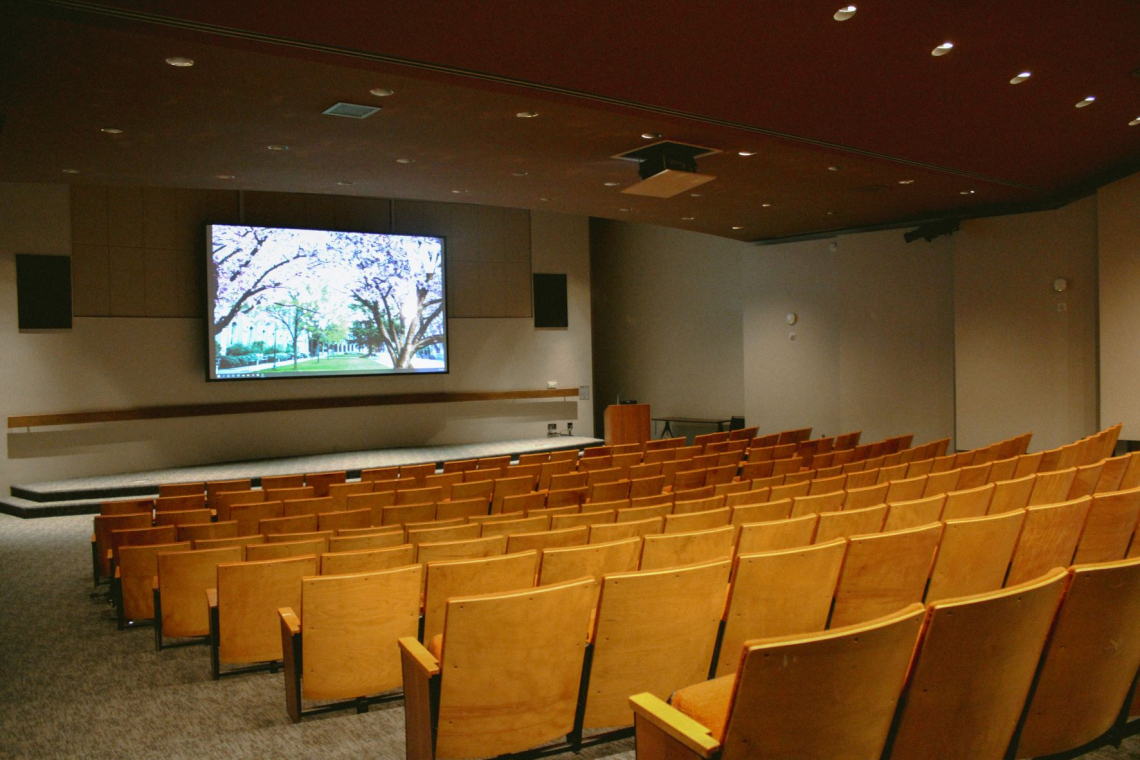 The mezzanine auditorium with an image of the quad cherry blossom trees in full bloom on the projector.