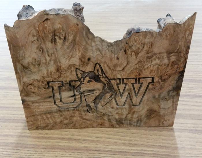 wood piece with UW and a husky engraved on it