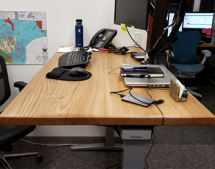 large wood desktop on a standing desk