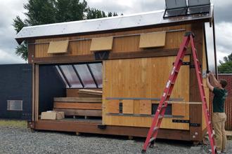 salvage wood solar kiln with wood being dried inside