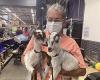 woman holding baby goats in a warehouse