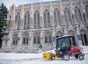 staff plowing snow in front of Suzzallo Library