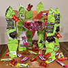 structure made out of wrappers with candy strewn around it