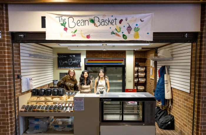 three happy students ready to greet customers at the uw bean basket counter