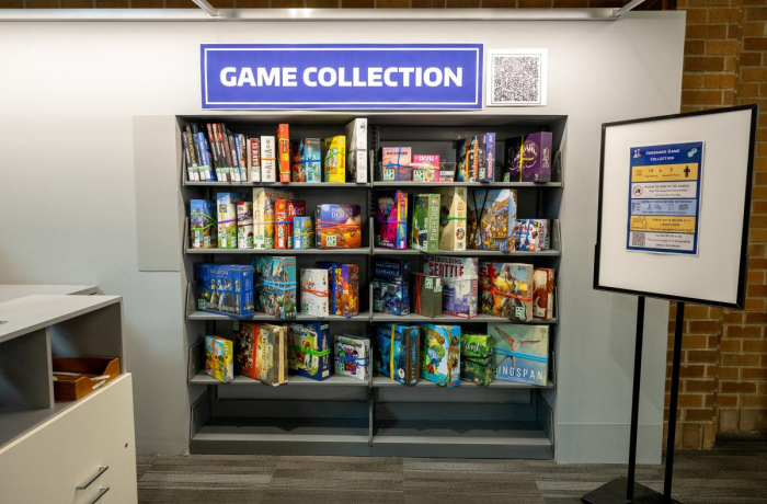 wall of board and card games with a poster that reads game collection