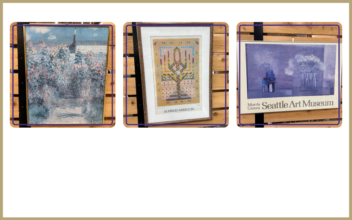 Three framed prints of art by three different artists