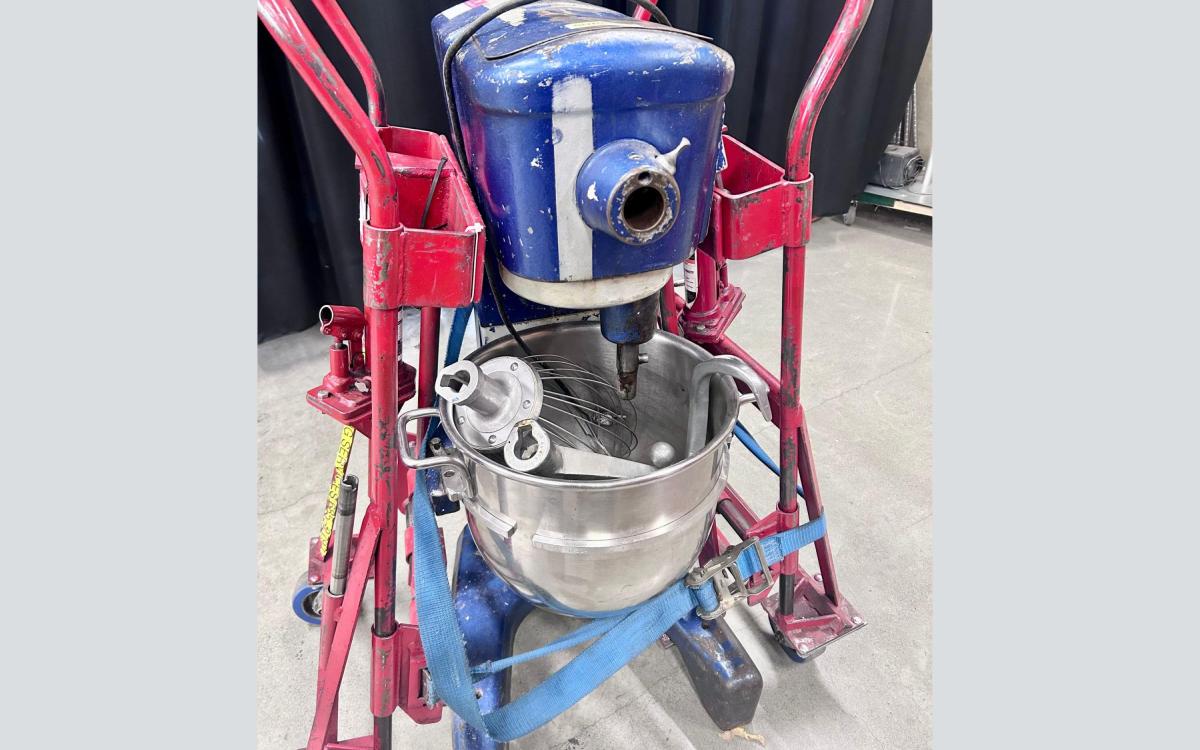 Blue and silver Hobart stand mixer, with attachments stored in the bowl.